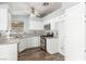 Bright kitchen featuring white cabinets, stainless steel appliances, and wood floors at 2842 Mahogany Grove Ave, Henderson, NV 89074