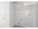 Bright laundry room with built-in shelving and connections for washer and dryer at 2842 Mahogany Grove Ave, Henderson, NV 89074