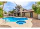 Backyard with a private pool, spa, and outdoor lighting, perfect for entertaining at 2842 Mahogany Grove Ave, Henderson, NV 89074