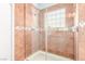 Tiled shower with glass door and patterned accent tile at 2842 Mahogany Grove Ave, Henderson, NV 89074