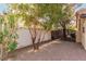 Gated side yard featuring mature trees and providing secure access to the property at 2842 Mahogany Grove Ave, Henderson, NV 89074