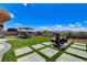 Spacious backyard featuring an outdoor gazebo, lounge area with fireplace, lush lawn, and mountain views at 2913 Grande Arch St, Henderson, NV 89044