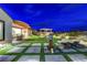 Relaxing backyard featuring a modern water feature, artificial turf, and covered patio seating area at 2913 Grande Arch St, Henderson, NV 89044