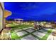 Expansive backyard with well-maintained lawn, covered seating area, and landscaped features, perfect for outdoor entertaining at 2913 Grande Arch St, Henderson, NV 89044