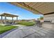 Inviting backyard with an outdoor kitchen, patio area, and covered seating, ideal for relaxation and gatherings at 2913 Grande Arch St, Henderson, NV 89044