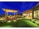 Stunning backyard with pergola, seating area, and lush landscaping, perfect for outdoor entertaining at 2913 Grande Arch St, Henderson, NV 89044