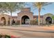 Elegant clubhouse entrance with stone archway, lush greenery, and manicured landscaping at 2913 Grande Arch St, Henderson, NV 89044