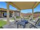 Comfortable covered patio featuring stylish lounge seating and an outdoor fire pit perfect for relaxation at 2913 Grande Arch St, Henderson, NV 89044