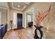 Elegant foyer with dark wood door, decorative vase and glass table, leading to the living areas, welcomes guests at 2913 Grande Arch St, Henderson, NV 89044