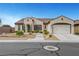 Inviting single-story home featuring a tile roof, low-maintenance landscaping, and a spacious two-car garage at 2913 Grande Arch St, Henderson, NV 89044