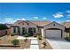 Charming single-story home featuring a well-manicured front yard, desert landscaping, and a two-car garage at 2913 Grande Arch St, Henderson, NV 89044