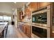 Gourmet kitchen featuring granite countertops, wood cabinets, and stainless steel appliances at 2913 Grande Arch St, Henderson, NV 89044