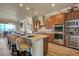 Modern kitchen with granite countertops, stainless steel appliances, and a breakfast bar with seating at 2913 Grande Arch St, Henderson, NV 89044