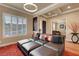 Cozy living room with plush sectional, plantation shutters, and stylish decor offers a comfortable atmosphere at 2913 Grande Arch St, Henderson, NV 89044