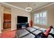 Stylish living room with black leather sectional and entertainment center, complemented by plantation shutters at 2913 Grande Arch St, Henderson, NV 89044