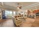 Open-concept living room with tile flooring, a large sectional sofa, and views of the backyard at 2913 Grande Arch St, Henderson, NV 89044