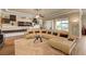 Spacious living room featuring tile floors, a large sectional couch, and contemporary decor at 2913 Grande Arch St, Henderson, NV 89044