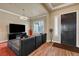 Inviting living room with modern black leather sectional, fireplace, and plantation shutters offers comfort and style at 2913 Grande Arch St, Henderson, NV 89044