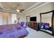 Spacious main bedroom featuring a ceiling fan, large windows, and a dresser at 2913 Grande Arch St, Henderson, NV 89044