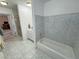 Bathroom with bathtub and a view into another room with the vanity and sink at 3110 National Ave, Pahrump, NV 89048