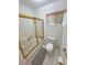 Bright bathroom featuring walk-in shower, toilet and window at 3110 National Ave, Pahrump, NV 89048