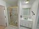 Bathroom with vanity, sink, and shower with glass doors and a shower chair at 3110 National Ave, Pahrump, NV 89048