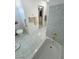 Bathroom with tiled floors, toilet, and bathtub with tiled surround at 3110 National Ave, Pahrump, NV 89048