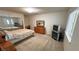 Bedroom featuring a queen-sized bed, sliding mirror closet, and wood furniture at 3110 National Ave, Pahrump, NV 89048