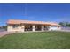 Charming single-story home with a covered porch, manicured lawn, and a terracotta-colored roof at 3110 National Ave, Pahrump, NV 89048