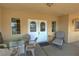 Inviting front porch featuring a seating area with glass table and outdoor seating at 3110 National Ave, Pahrump, NV 89048
