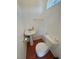 Compact half bathroom featuring a pedestal sink, toilet, and tiled flooring at 3110 National Ave, Pahrump, NV 89048