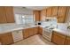 Classic kitchen featuring wooden cabinets, white countertops, and stainless steel appliances at 3110 National Ave, Pahrump, NV 89048