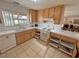 Traditional kitchen with wooden cabinets, white appliances, and a garden window at 3110 National Ave, Pahrump, NV 89048