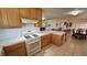 View of kitchen with gas range, wooden cabinets, and breakfast bar connecting to dining area at 3110 National Ave, Pahrump, NV 89048