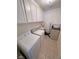 Functional laundry room with washer, dryer, storage cabinets, and utility sink at 3110 National Ave, Pahrump, NV 89048