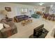 Bright living room with neutral walls, carpeting, and open layout to the kitchen and dining areas at 3110 National Ave, Pahrump, NV 89048