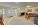 Living room boasts tile floors and neutral decor, seamlessly connecting to the kitchen and dining spaces at 3110 National Ave, Pahrump, NV 89048