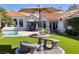 Beautiful backyard with lush lawn, pool, patio furniture, and mature landscaping at 3240 W Richmar Ave, Las Vegas, NV 89139