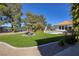 Expansive backyard featuring green grass, mature trees, and outdoor dining space by the sparkling swimming pool at 3240 W Richmar Ave, Las Vegas, NV 89139