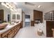 Luxurious bathroom with dual sinks, soaking tub with fireplace, and access to bedroom at 3240 W Richmar Ave, Las Vegas, NV 89139