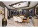 Modern dining room with a stylish chandelier, elegant furniture, and sophisticated decor, perfect for entertaining at 3240 W Richmar Ave, Las Vegas, NV 89139