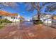 Spacious driveway leading to a home with a beautiful white exterior and a three car garage at 3240 W Richmar Ave, Las Vegas, NV 89139