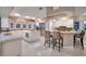 Bright kitchen featuring a large island with marble countertops, stainless steel appliances, and bar stool seating at 3240 W Richmar Ave, Las Vegas, NV 89139