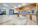 Well-lit kitchen with custom cabinetry, marble countertops, stainless steel appliances, and a spacious central island at 3240 W Richmar Ave, Las Vegas, NV 89139