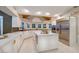 Spacious kitchen with a large center island, stainless steel appliances, and white cabinets and countertops at 3240 W Richmar Ave, Las Vegas, NV 89139