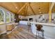 Open floor plan living room with wood flooring, vaulted ceilings, kitchen view, and view to landscaped yard at 3240 W Richmar Ave, Las Vegas, NV 89139