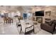 Open-concept living area with a stone fireplace, modern seating, and seamless flow to the kitchen and breakfast bar at 3240 W Richmar Ave, Las Vegas, NV 89139