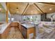 Open concept living room and kitchen with wood floors, coffered wood ceiling and outside views at 3240 W Richmar Ave, Las Vegas, NV 89139