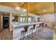Open concept living room featuring a view to the outside and a view of the kitchen bar and seating area at 3240 W Richmar Ave, Las Vegas, NV 89139