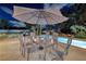 Outdoor patio seating under a large umbrella, creating a perfect spot for al fresco meals by the pool at 3240 W Richmar Ave, Las Vegas, NV 89139